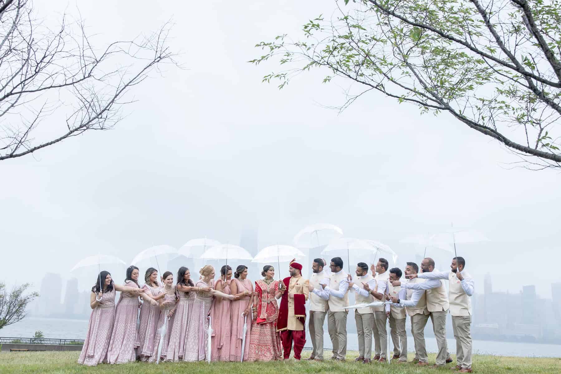 Bridal and groom party during rain on wedding day